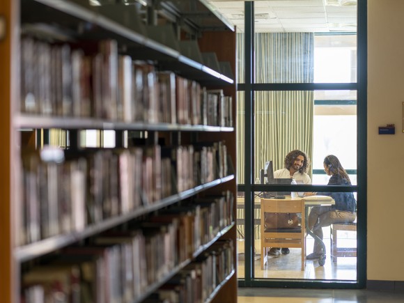 two students studying in the library building