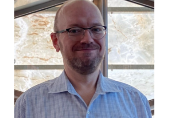 Man with glasses smiling