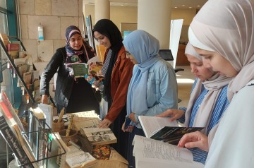 A group of veiled ladies looking at books